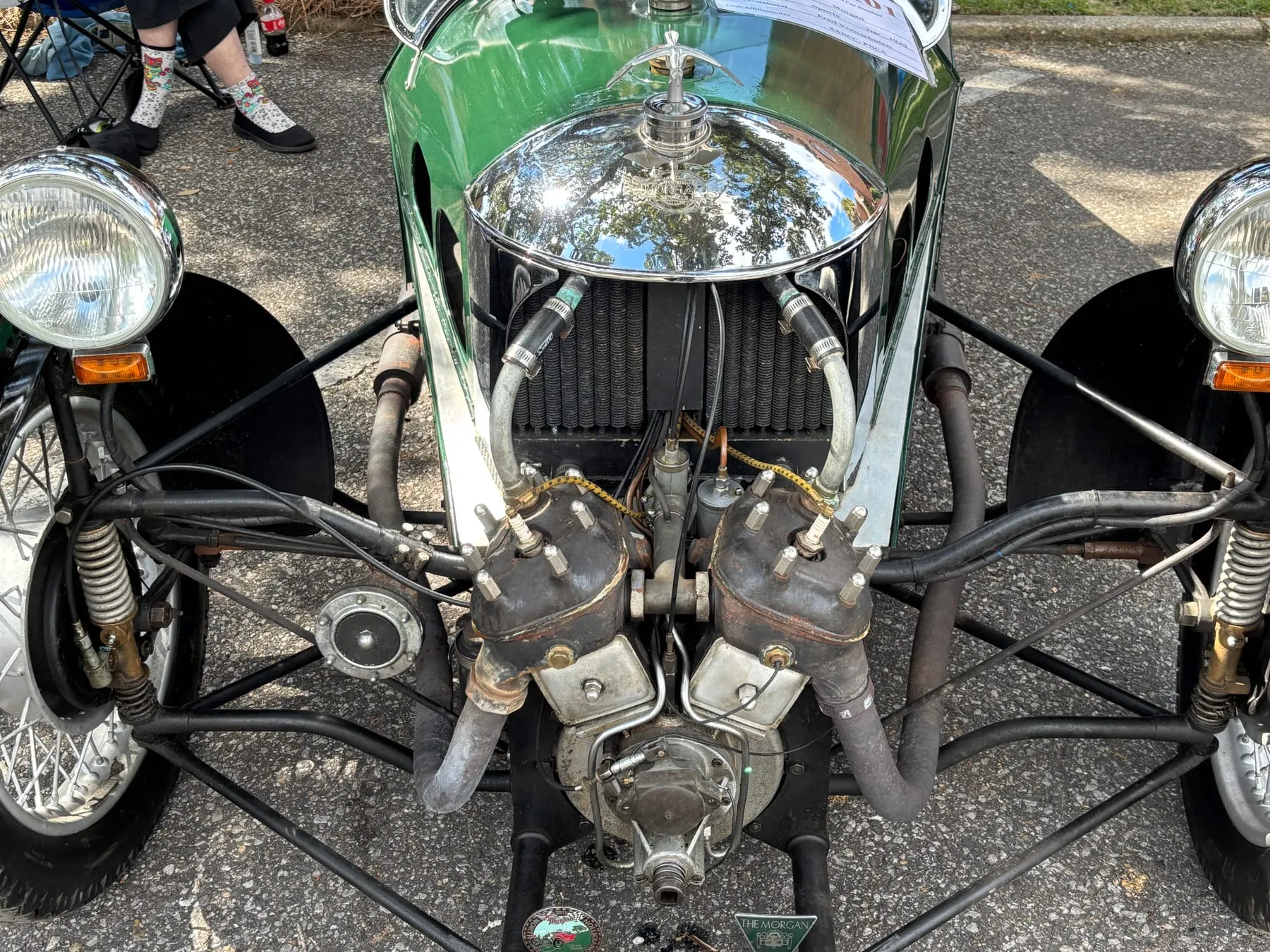 The front of a 1929 Morgan three-wheeler: a V-twin engine out in front of the radiator, between two lamps
