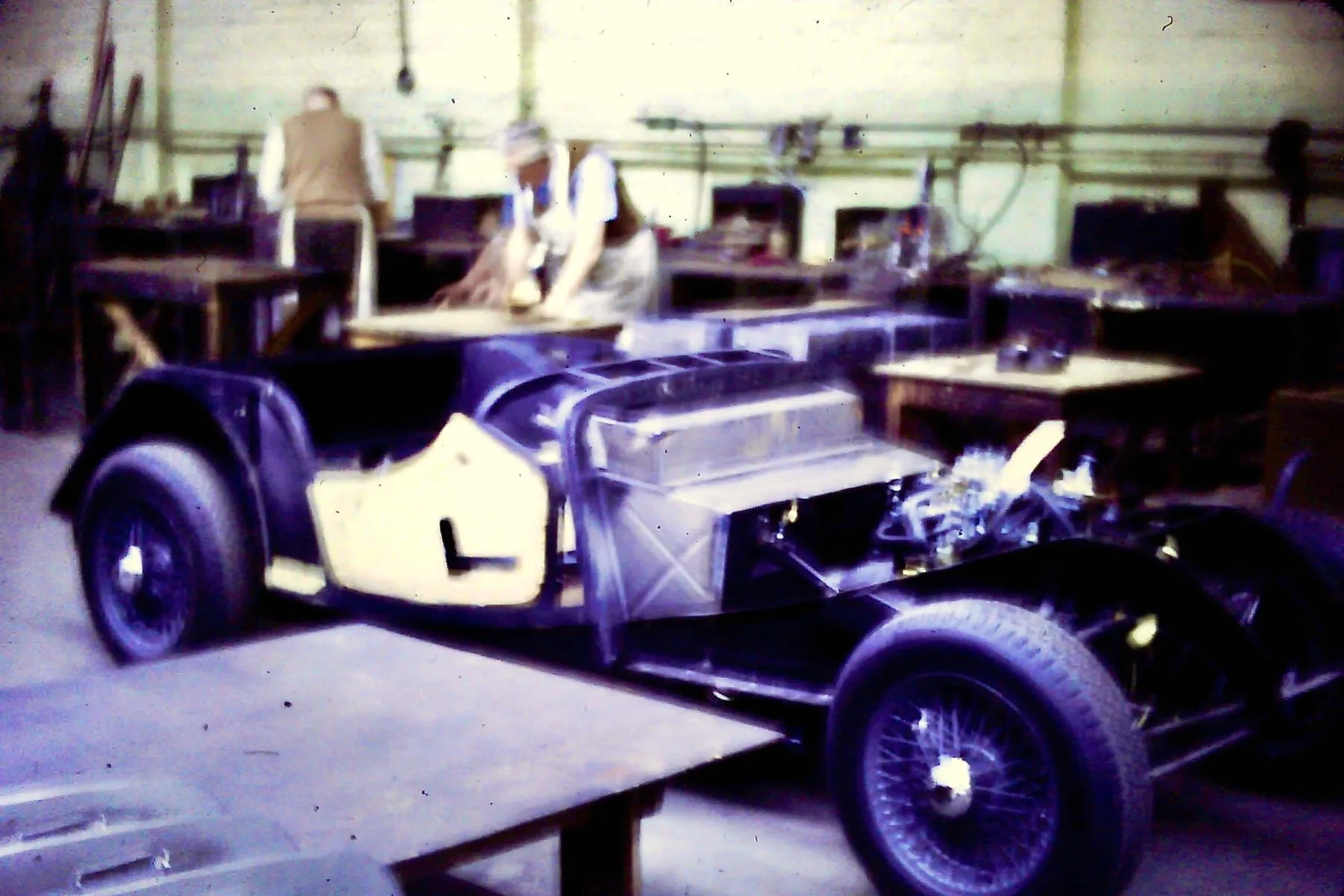 A worker fitting an outer panel to a partly assembled Morgan