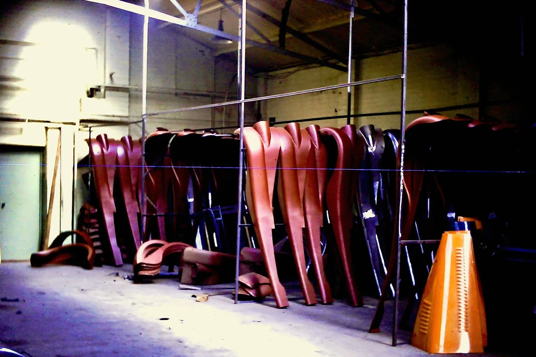 Rows of body panels stored upright in the workshop