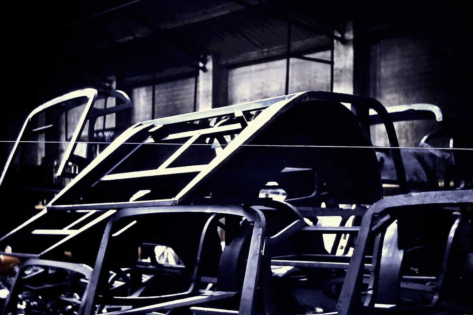 Wooden Morgan body frames stored together inside a workshop