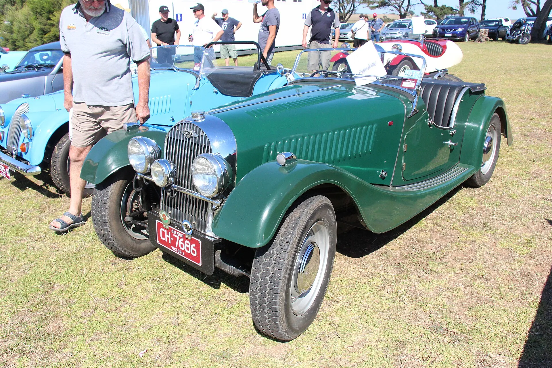 A dark-green 1951 Morgan Plus 4 roadster with a flat radiator, seen from the front three-quarters