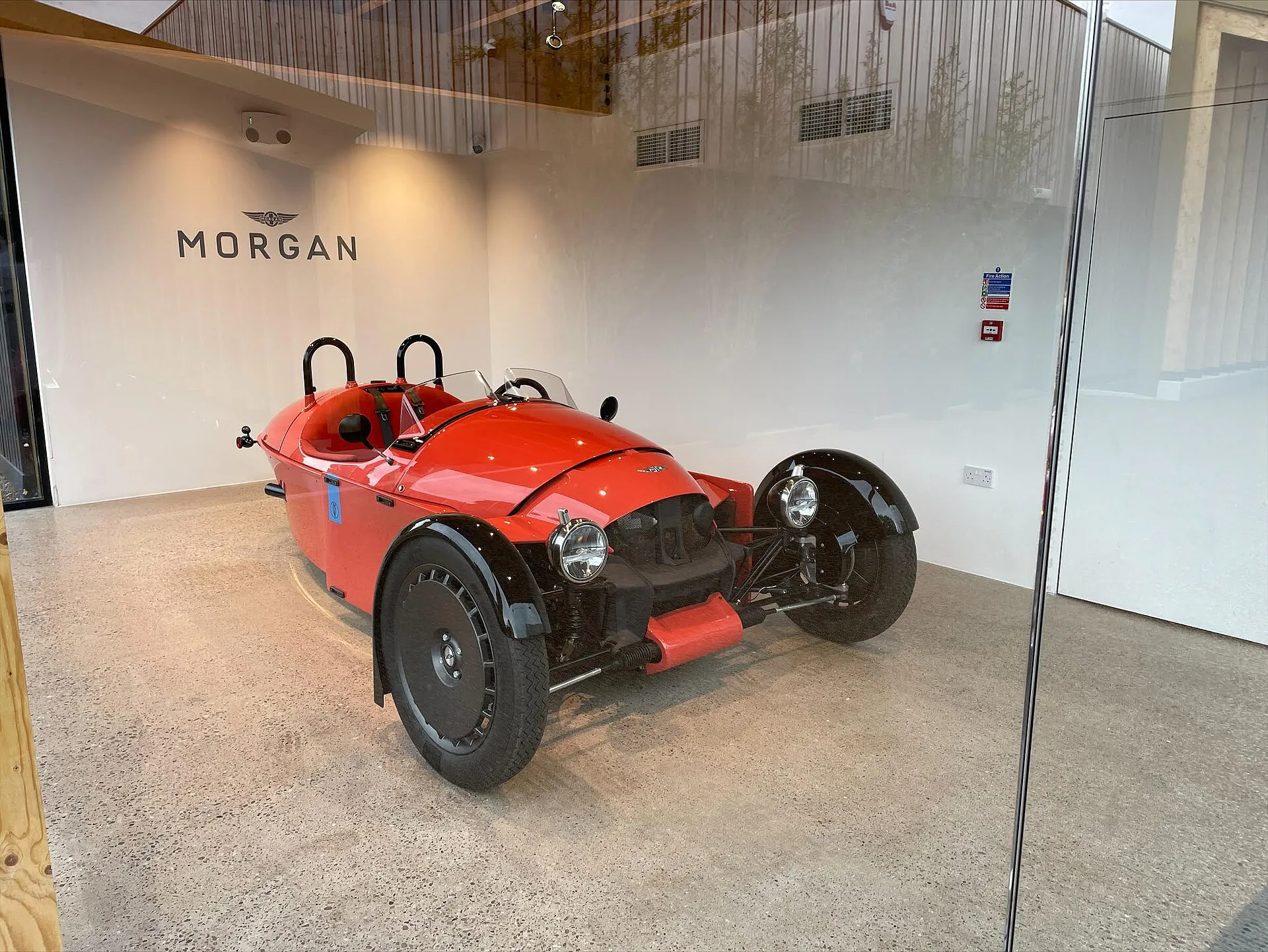 A red Morgan Super 3 on display in the Morgan Experience centre