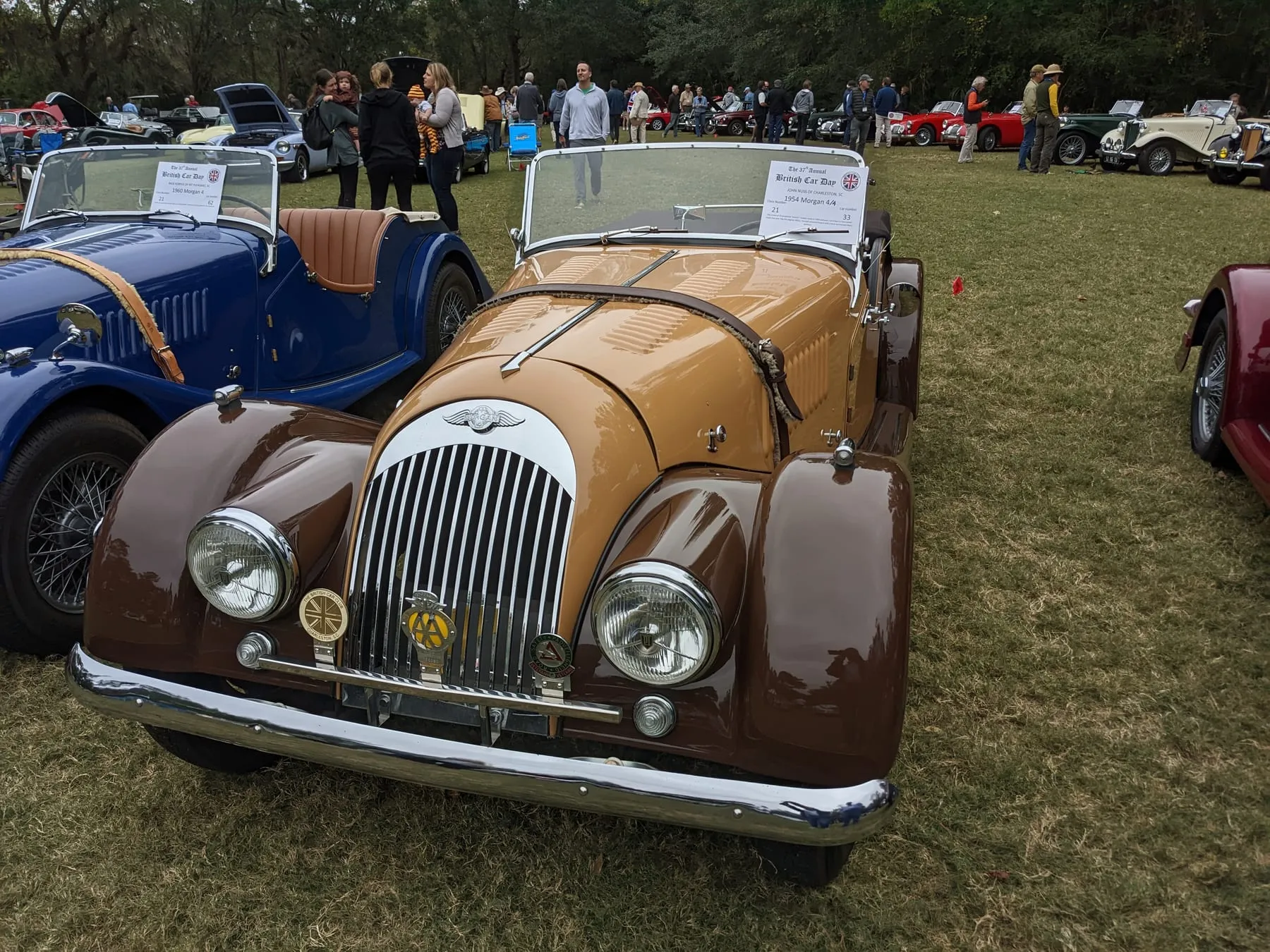 A tan and brown 1954 Plus 4 four-seater from the front, at a car show