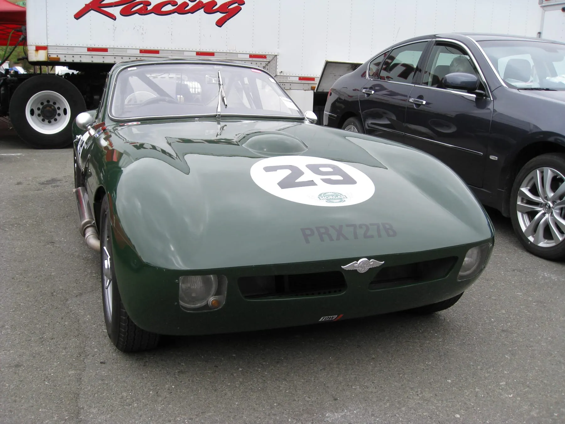 A dark-green Morgan SLR coupé, race number 29, from the front in the Sonoma paddock